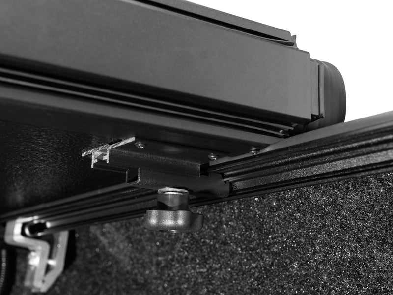 Gator EFX hard folding tonneau cover: Close-up of the folded cover stack and clamp on the rail over a spray-in liner