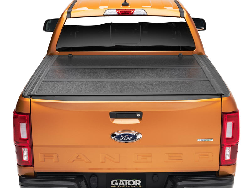 Gator EFX hard folding tonneau cover: Rear view of an orange Ford Ranger with the black hard tri-fold cover closed