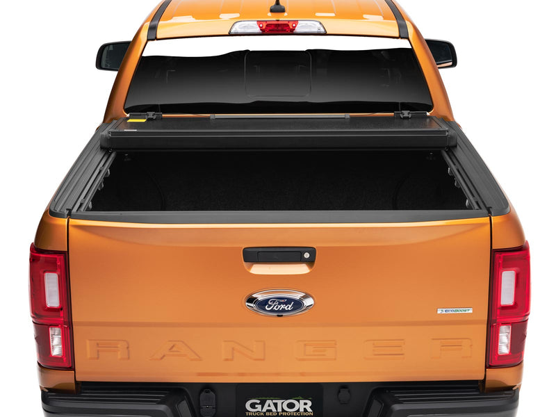 Gator EFX hard folding tonneau cover: Rear view of an orange Ford Ranger with the hard tri-fold cover folded toward the cab