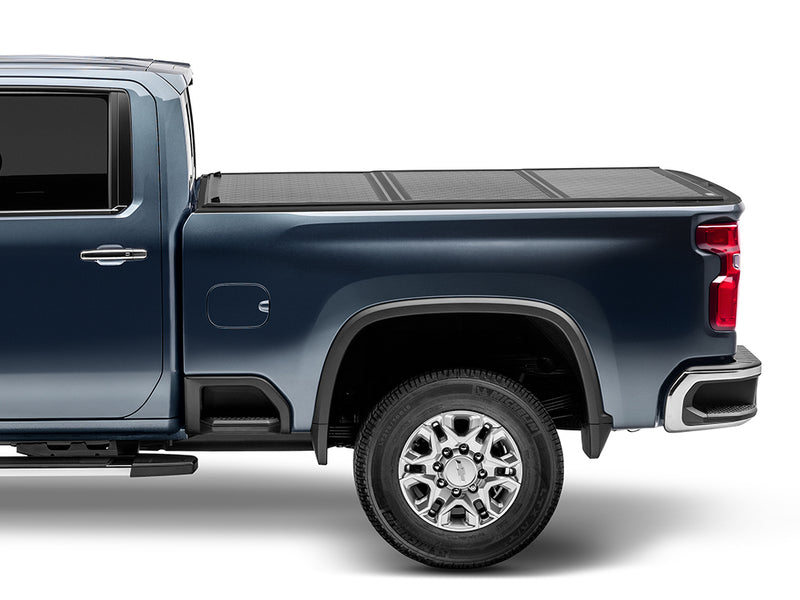 Gator EFX hard folding tonneau cover: Side view of a blue heavy duty pickup with a closed black hard folding cover