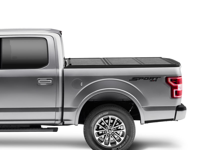 Gator EFX hard folding tonneau cover: Side view of a silver Ford F-150 with a low-profile hard tri-fold cover closed