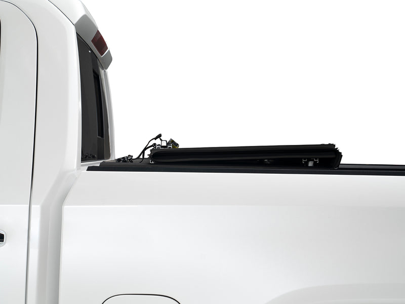 Gator EFX hard folding tonneau cover: Side view of a white pickup with the hard cover folded into a stack against the cab