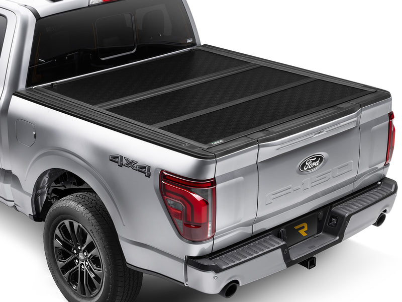 Gator EFX hard folding tonneau cover: Silver Ford F-150 4x4 from the rear three-quarter with the black hard tri-fold cover closed