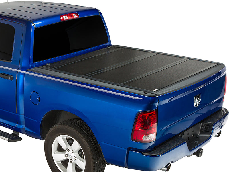 Gator FX hard folding tonneau cover: closed on a blue pickup, rear three-quarter view