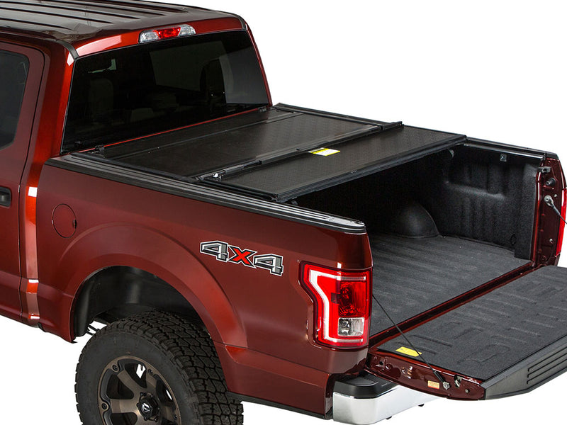 Gator FX hard folding tonneau cover: rear panel folded forward on a red Ford pickup, tailgate down