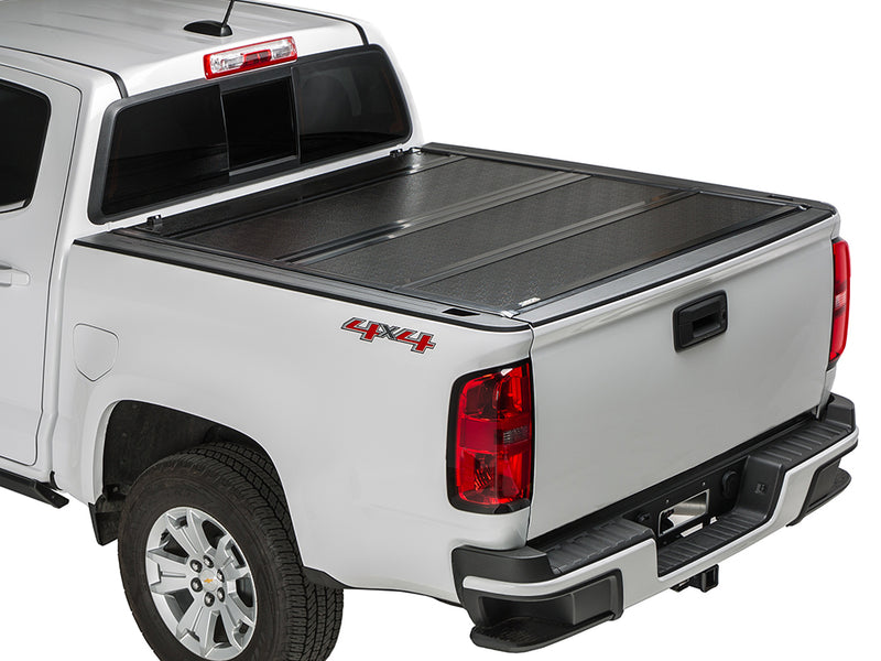 Gator FX hard folding tonneau cover: closed on a white midsize pickup, rear three-quarter view