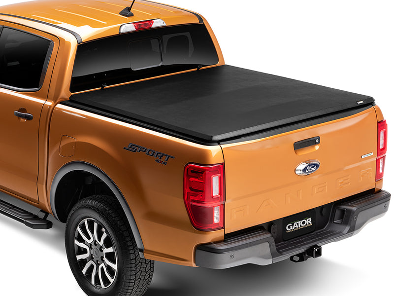 Gator SFX soft tri-fold tonneau cover: closed on an orange Ford midsize pickup, rear three-quarter view