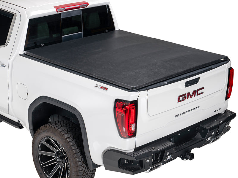 Gator SFX soft tri-fold tonneau cover: closed on a white GMC pickup, rear three-quarter view