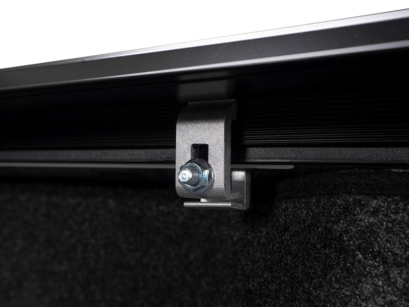 Gator SRX soft roll-up tonneau cover: Close-up of a metal clamp securing a soft roll-up tonneau rail under the bed rail