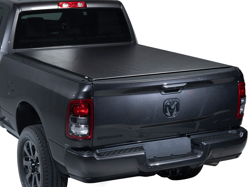 Gator SRX soft roll-up tonneau cover: Gray Ram pickup with a black soft roll-up tonneau cover closed over the bed, rear three-quarter view