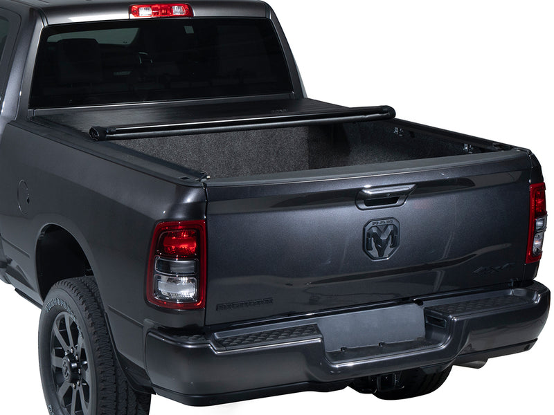 Gator SRX soft roll-up tonneau cover: Gray Ram pickup with a soft roll-up tonneau cover partly rolled, showing a carpeted bed liner