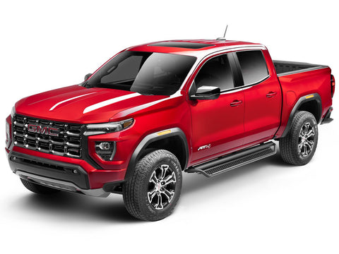 Go Rhino Dominator D1: red GMC Canyon AT4 crew cab with black side steps, front three-quarter view