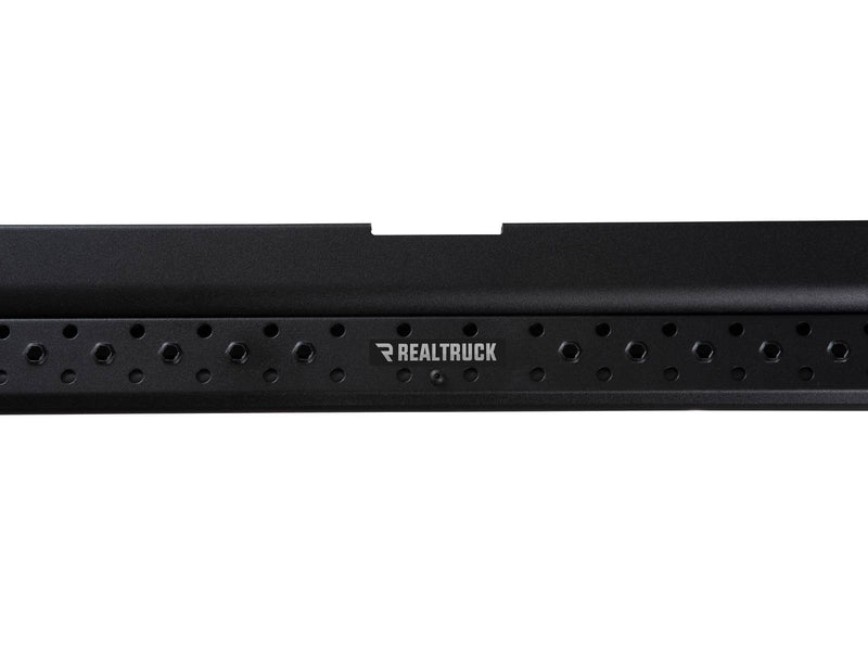 Go Rhino Dominator DSS: close-up of a black slider board side rail with perforations and RealTruck badge plate