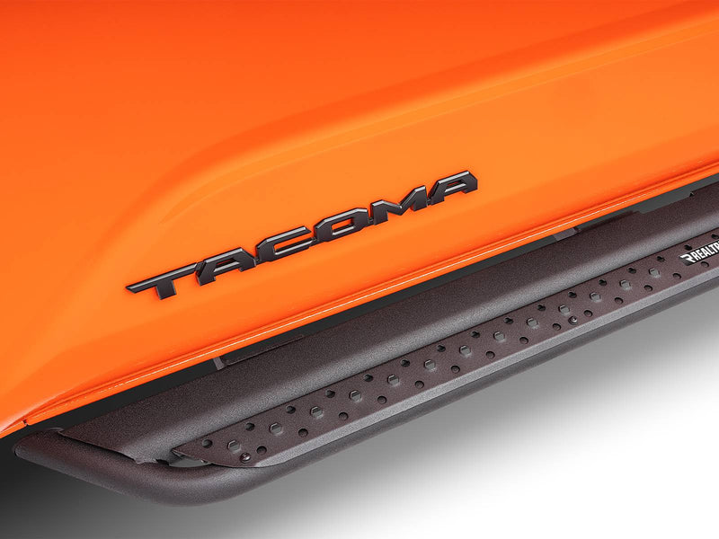 Go Rhino Dominator DSS: close-up of a black slider step under the TACOMA door lettering of an orange truck
