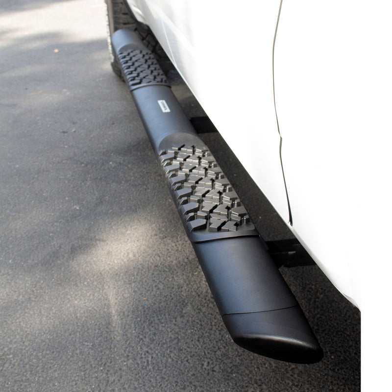 Go Rhino V-Series V3: black side step with tread pads fitted under a white truck door