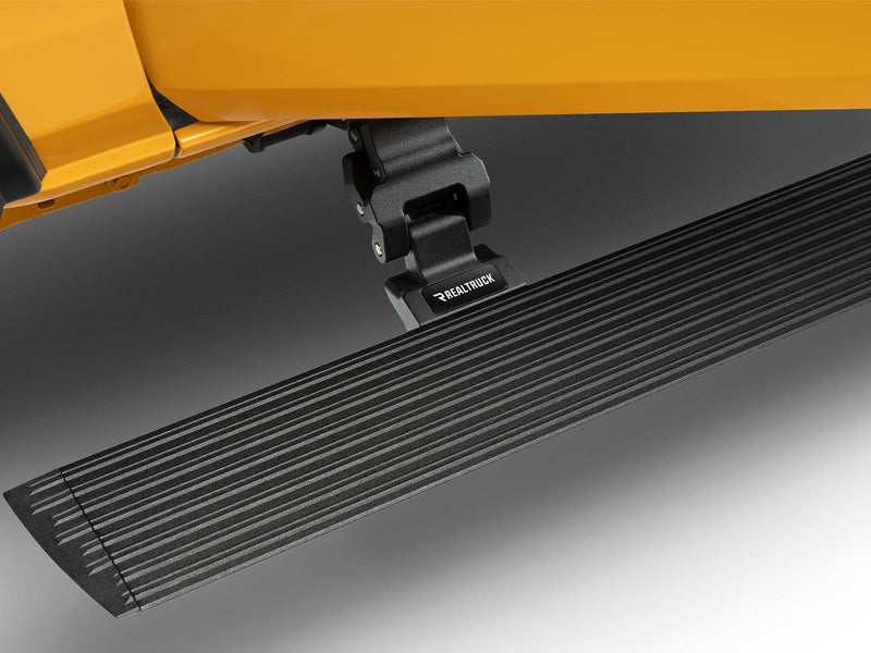 Textured black power running board deployed below a yellow body, close-up of the motor arm and step