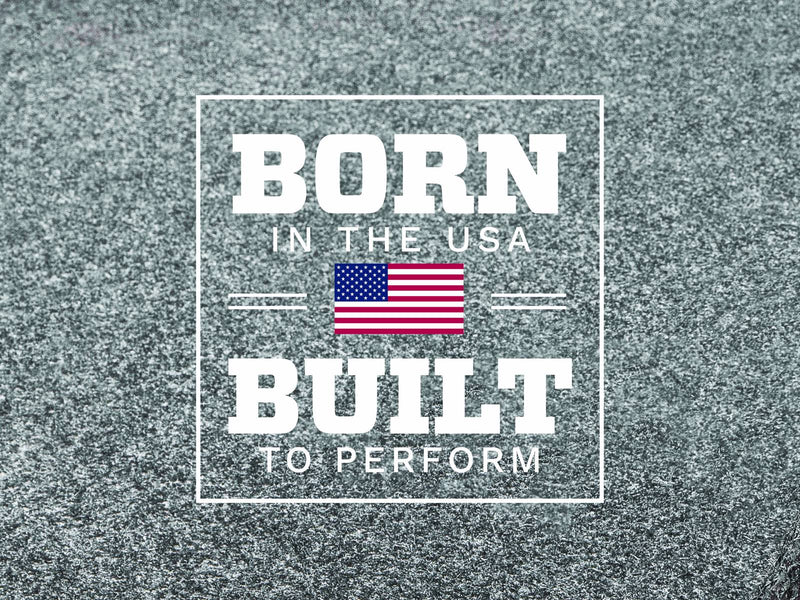 Husky Liners Guardian Comfort: born in the USA, Built to Perform graphic with US flag over gray carpet texture