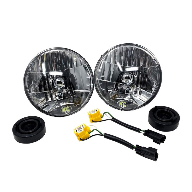 KC HiLiTES 7" H4 DOT Halogen Headlight Pair with H13 Adapters on a studio background: pair of KC 7" round H4 halogen headlights with two adapter cables and two rubber dust boots