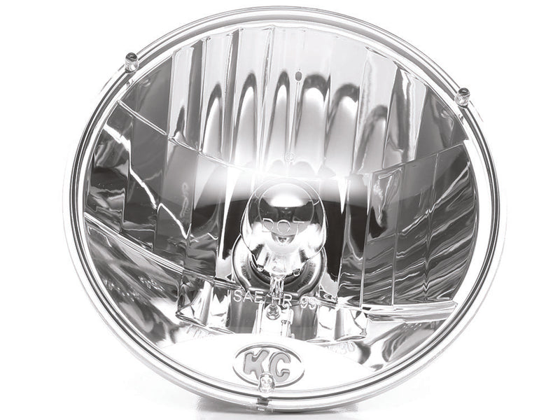 KC HiLiTES 7" H4 DOT Halogen Headlight Pair with H13 Adapters on a studio background: round 7" clear halogen headlight with faceted reflector and KC logo on the lens, front view on white