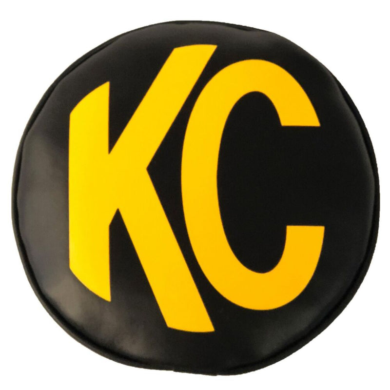 KC HiLiTES 8" Round Light Cover Pair on a studio background: round black soft vinyl light cover with a yellow KC logo on a white background