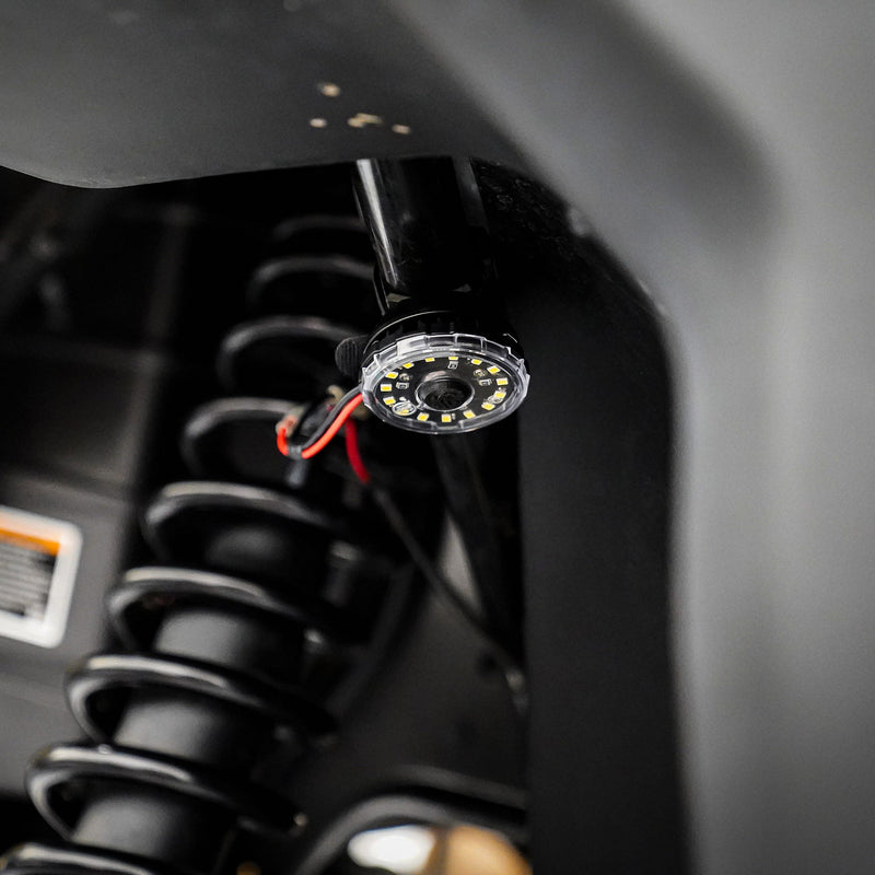 KC HiLiTES Cyclone V2 LED Light on a vehicle: single round clear LED light mounted inside a wheel well beside a black coil-over shock