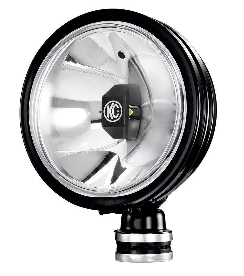 KC HiLiTES Daylighter 6" Gravity LED Light on a studio background: black round LED light with a clear lens, chrome reflector and KC logo on the center module, angled view on white