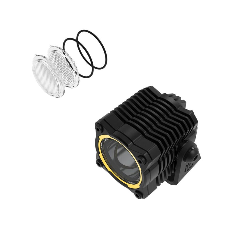 KC HiLiTES FLEX ERA 1 LED Light Pod Master Kit on a studio background: A single FLEX ERA 1 LED cube light pod with a yellow accent ring, spare clear lenses and O-rings on a white background