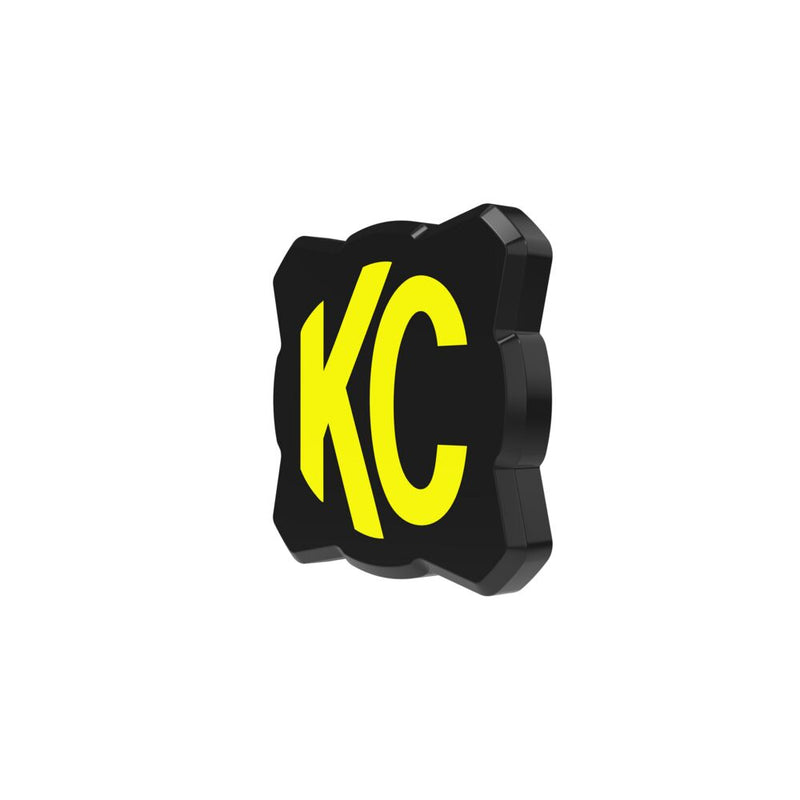 KC HiLiTES FLEX ERA 1 Light Cover & Shield on a studio background: black FLEX ERA 1 light cover with a yellow KC logo, angled render on white
