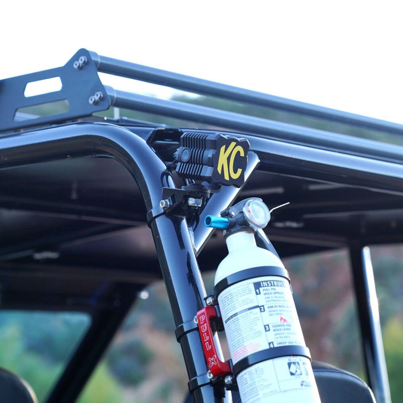 KC HiLiTES FLEX ERA 1 Light Cover & Shield on a vehicle: KC FLEX ERA 1 light with a black and yellow KC cover mounted on a UTV roll cage above a fire extinguisher