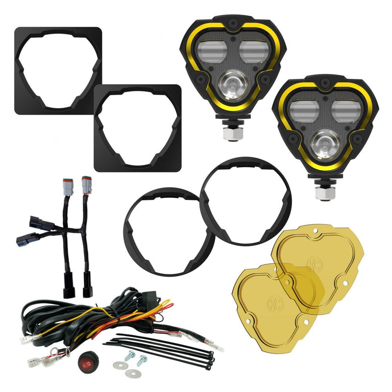 KC HiLiTES FLEX ERA 3 Dual-Mode SAE Fog Light Kit, Aftermarket Bumper on a studio background: FLEX ERA 3 fog light kit laid out: two lights, square and round shrouds, harness adapters, wiring harness with switch and two yellow lenses