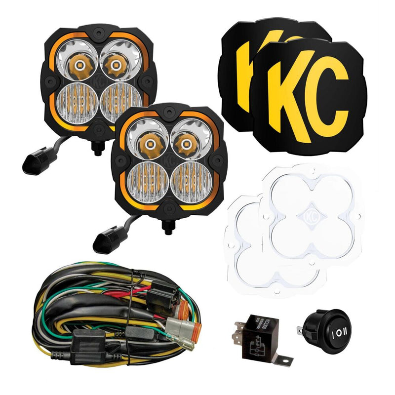 KC HiLiTES FLEX ERA 4 LED Light Pod Master Kit on a studio background: two KC FLEX ERA 4 LED light pods with two black KC covers, two clear lenses, a wiring harness, relay and rocker switch on a white background