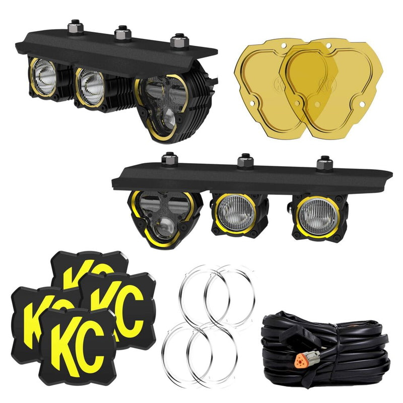 KC HiLiTES FLEX ERA SAE Fog Pocket Light Kit on a studio background: Bronco fog pocket kit laid out: two bracket assemblies with lights, two yellow lenses, four KC covers, four clear lenses and a wiring harness