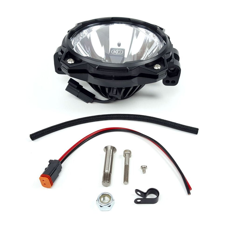 KC HiLiTES Gravity Pro6 LED Add-On Driving Light System on a studio background: single KC Gravity Pro6 add-on LED light with wiring lead, connector, bolts, nut and cable clamp on white