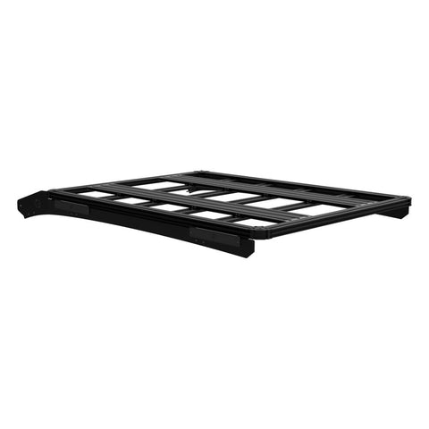 KC HiLiTES Platform One Roof Rack on a studio background: black aluminum KC Platform One roof rack with slotted crossbars and side mounting brackets, front three-quarter view on a white background