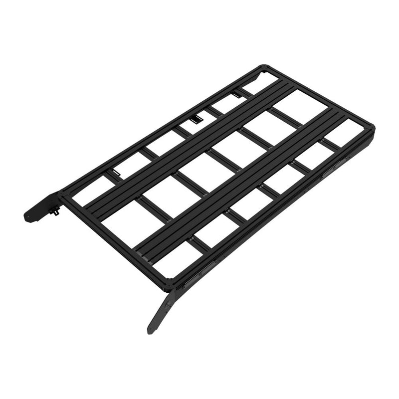 KC HiLiTES Platform One Roof Rack on a studio background: black aluminum KC Platform One roof rack with slotted crossbars and side mounting brackets, elevated top-down three-quarter view on a white background