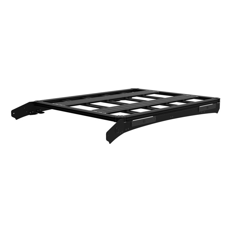 KC HiLiTES Platform One Roof Rack on a studio background: black aluminum KC Platform One roof rack with slotted crossbars and side mounting brackets, front three-quarter view on a white background