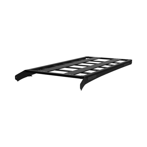 KC HiLiTES Platform One Roof Rack on a studio background: black aluminum rack at a three-quarter angle showing the slotted crossbars and front fairing