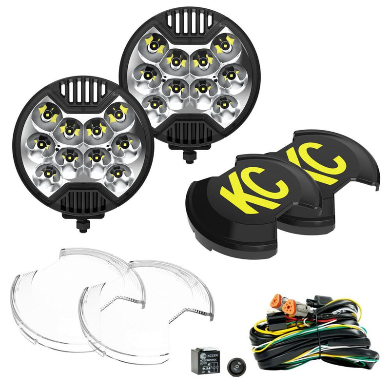 KC HiLiTES SlimLite 6" LED Light Master Kit on a studio background: two round LED lights with two black KC covers, two clear lenses and a wiring harness with switch and relay