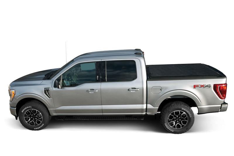 LEER SR250 soft roll-up tonneau cover on a pickup bed: side profile of a silver pickup with a black soft roll-up cover closed over the bed