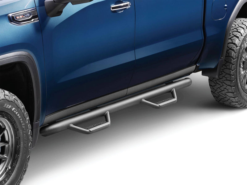N-Fab cab length nerf step bars in textured black installed below the doors of a blue pickup