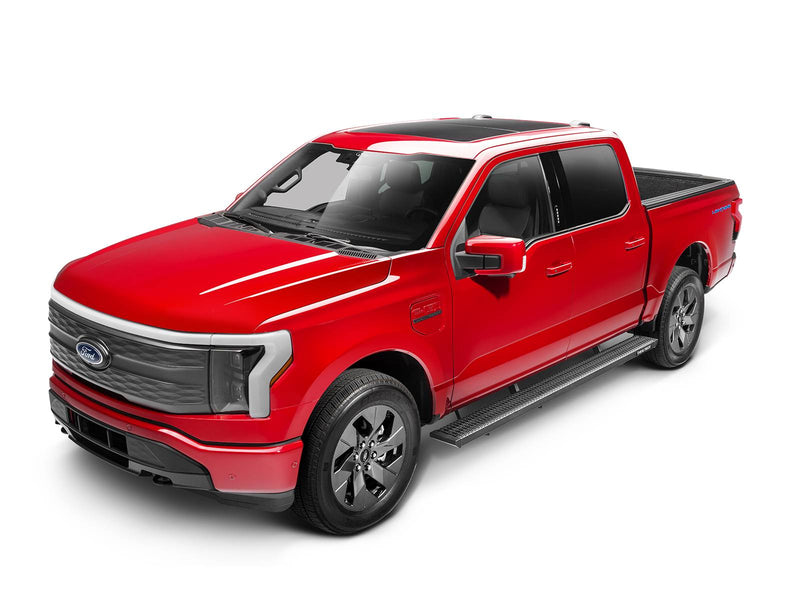 Front three-quarter view of a red Ford F-150 Lightning crew cab fitted with N-Fab Growler Fleet grip-plate side steps