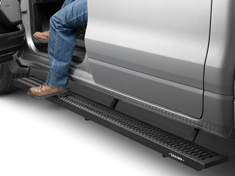 N-Fab Growler Fleet side steps in textured black, boot on the step at an open door, on a Ram 1500