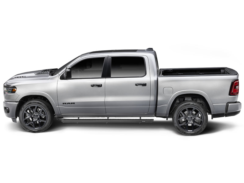 N-Fab Growler Fleet side steps in textured black, side profile, installed along the rocker, on a Ram 1500
