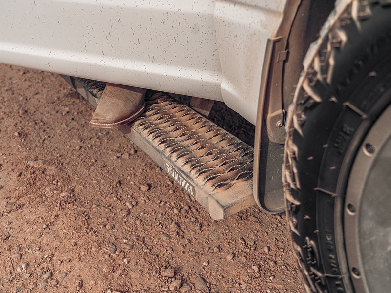 Muddy work boot on a dirt-dusted N-Fab Growler Fleet grip-plate side step