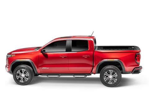 N-Fab Predator Pro nerf steps in textured black, side profile, installed along the rocker, on a GMC Canyon