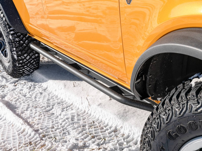 N-Fab TrailSlider step system in textured black, overhead view, installed along the rocker in snow