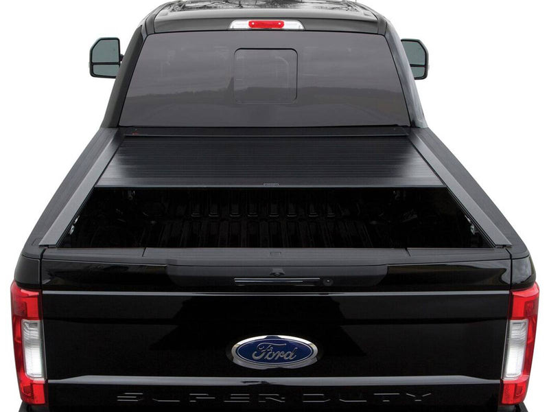 Pace Edwards BedLocker: rear view of a black pickup with the retractable cover about halfway open