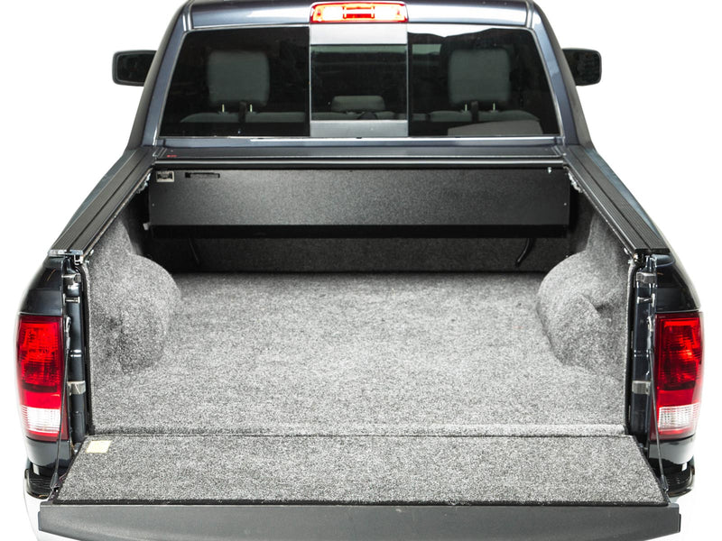 Pace Edwards BedLocker: rear view of a pickup bed with the cover fully retracted into the front canister, tailgate down