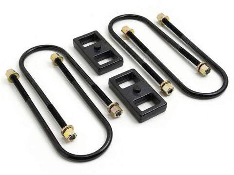 ReadyLIFT 1" Rear Block Kit, on a studio background: two black 1" cast iron rear lift blocks with U-bolts and nuts