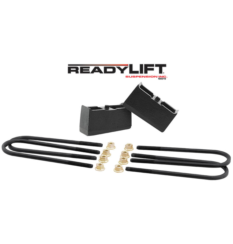 ReadyLIFT Block Kit, full kit on a studio background: two black cast tapered rear lift blocks with round black U-bolts and gold nuts under a ReadyLIFT logo